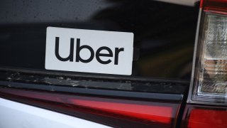 An Uber sticker is seen on a car at the start of a protest by ride share drivers.