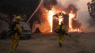 Firefighters work to prevent the fire from spreading during the Zogg fire.
