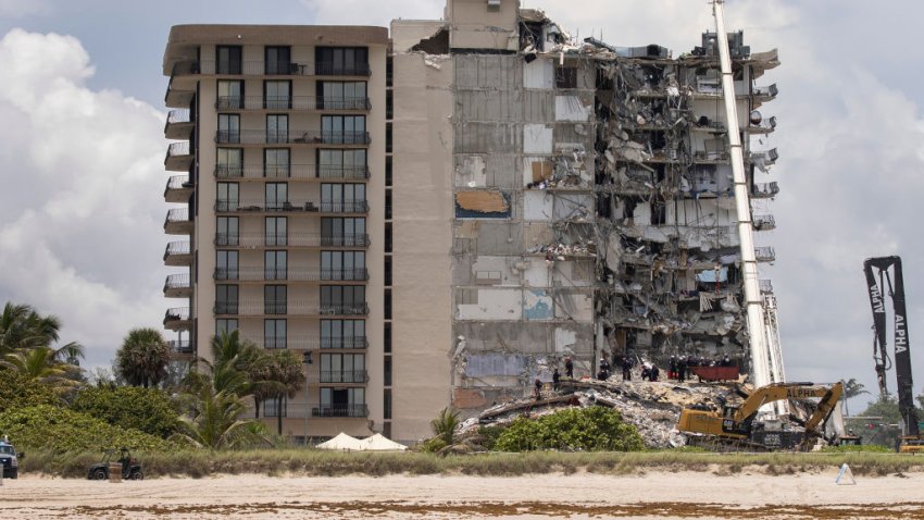 SURFSIDE, FLORIDA – JUNE 26: Members of the South Florida Urban Search and Rescue team look for possible survivors in the partially collapsed 12-story Champlain Towers South condo building on June 26, 2021 in Surfside, Florida. Over 150 people are being reported as missing as search-and-rescue efforts continue with rescue crews from across Miami-Dade and Broward counties. (Photo by Joe Raedle/Getty Images)