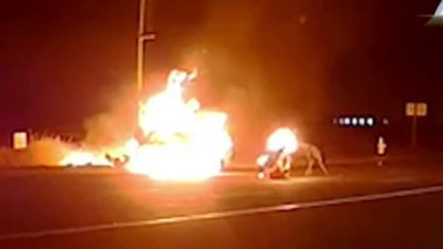 En video: policía ayuda a mujer a salir de un auto envuelto en llamas