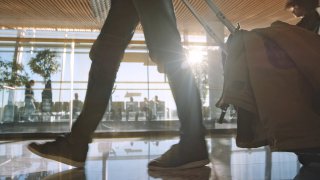 Shot from the floor of a person walking in an airport