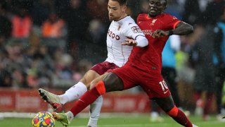Matthew Cash of Aston Villa battles for possession with Sadio Mane of Liverpool during the Premier League match between Liverpool and Aston Villa at Anfield on Dec. 11, 2021 in Liverpool, England.