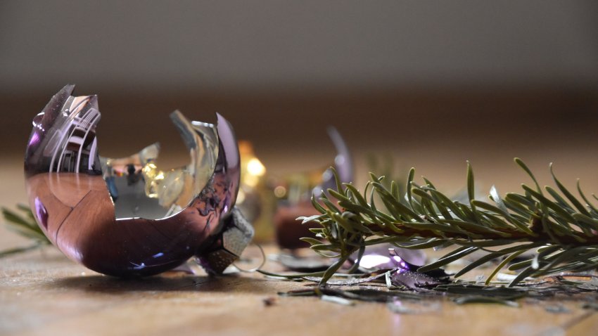 A broken christmas tree decoration, quarrel, fight, argument, x -mas, glass bulb, unhappy, family apart, sadness, pine, floor, damage, friendship, relationship, end,loss, sadness, loneliness,solitude