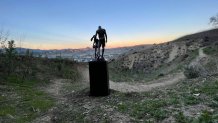 A sculpture of Kobe and Gianna Bryant is pictured Jan. 26, 2022 at the site of the helicopter crash that killed nine people.