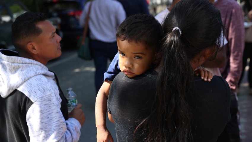 Martha’s Vineyard, MA – September 15: A mother and child spent some time outside the St. Andrew’s Parrish House where migrants were being fed lunch with donated food from the community. Two planes of migrants from Venezuela arrived suddenly Wednesday night on Martha’s Vineyard.