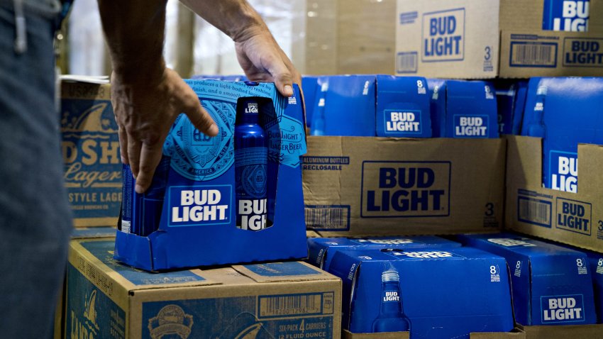 An employee adjusts bottles of Bud Light beer at an Anheuser-Busch InBev facility in Virginia, Aug. 8, 2018.