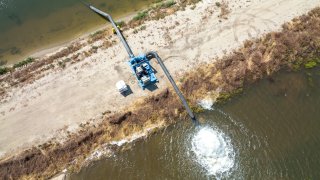 A drone view of the James Irrigation District utilizing pumps from DWR’s Emergency Pump Program to divert water and fill a basin for groundwater recharge in San Joaquin Fresno County, California. Photo taken May 26, 2023.