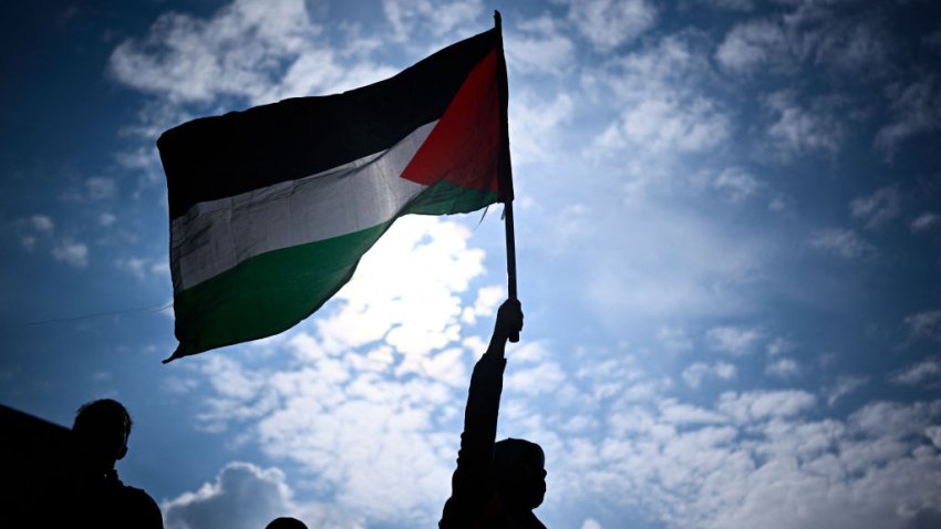 TOPSHOT – A protester holds a Palestinian flag during a rally called by several French organisations in support of Palestinian people at Place de la Republique in Paris on May 7, 2024. In an echo of tense demonstrations rocking many top US universities, students of several cities have staged a number of protests, with some students furious over the Israel-Hamas war and ensuing humanitarian crisis in the besieged Palestinian territory of Gaza. (Photo by JULIEN DE ROSA / AFP) (Photo by JULIEN DE ROSA/AFP via Getty Images)