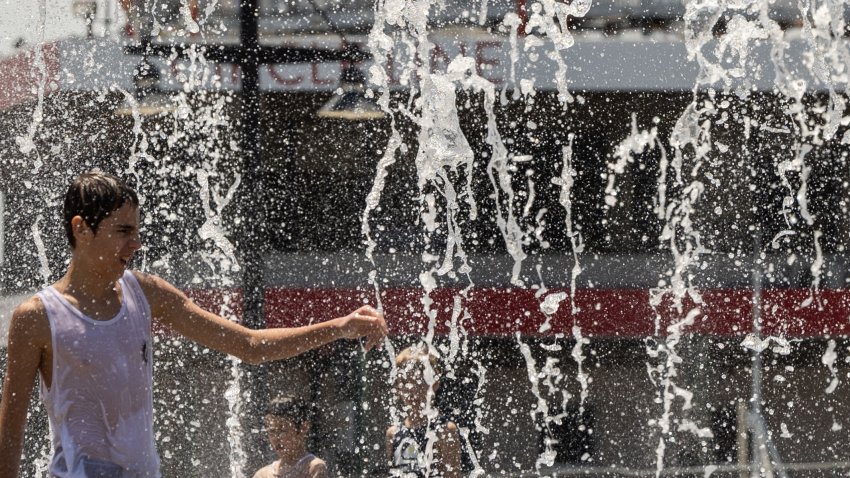 A person cools off in a water fountain near the Hudson River during a heatwave on June 20, 2024 in New York City. Deadly heat that has blanketed the US, Mexico and Central America recently was made 35 times more likely due to global warming, World Weather Attribution (WWA) climate scientists said on June 20. (Photo by Yuki IWAMURA / AFP) (Photo by YUKI IWAMURA/AFP via Getty Images)