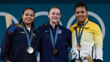 Gold medallist US' Olivia Reeves (C), silver medallist Colombia's Mari Leivis Sanchez (L) and bronze medallist Ecuador's Angie Paola Palacios Dajomes (R) pose on the podium after the women's -71kg weightlifting event during the Paris 2024 Olympic Games at the South Paris Arena in Paris, on August 9, 2024. (Photo by Dimitar DILKOFF / AFP) (Photo by DIMITAR DILKOFF/AFP via Getty Images)