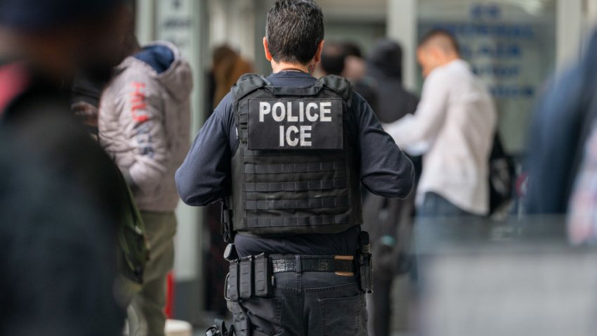 NEW YORK, NEW YORK – JUNE 6: An ICE agent monitors hundreds of asylum seekers being processed upon entering the Jacob K. Javits Federal Building on June 6, 2023 in New York City. New York City has provided sanctuary to over 46,000 asylum seekers since 2013, when the city passed a law prohibiting city agencies from cooperating with federal immigration enforcement agencies unless there is a warrant for the person’s arrest.(Photo by David Dee Delgado/Getty Images)