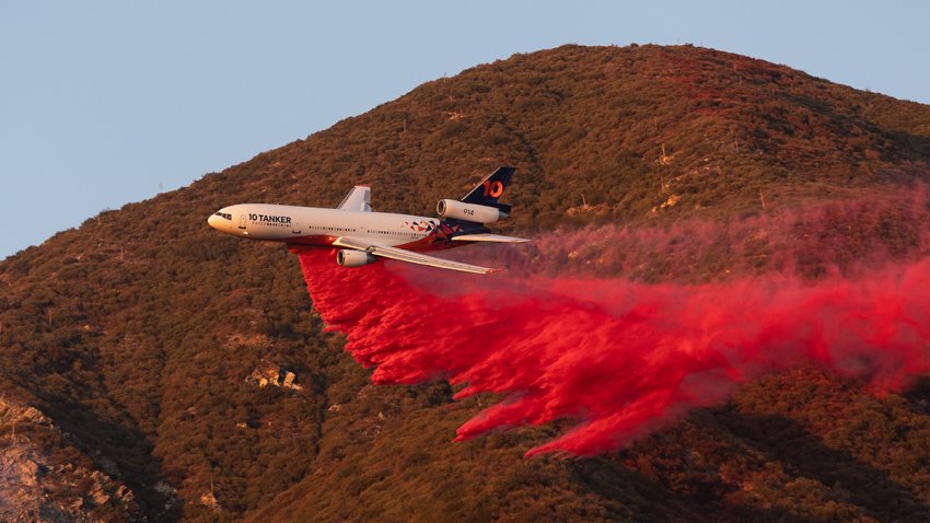 A plane drops fire retardant during the Eaton Fire near Altadena, California, US, on Monday, Jan. 13, 2025. Southern California faces another round of dangerous fire weather set to begin Monday night, even as crews struggle to contain wind-driven blazes that have paralyzed Los Angeles for nearly a week and killed at least 24 people. Photographer: Benjamin Fanjoy/Bloomberg via Getty Images