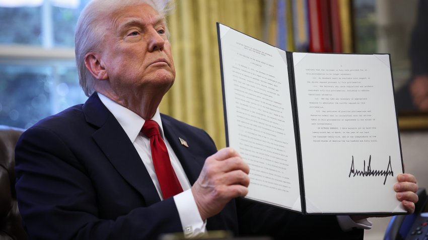 WASHINGTON, DC – MARCH 26: U.S. President Donald Trump displays a signed an executive order in the Oval Office of the White House on March 26, 2025 in Washington, DC. President Trump announced 25% tariffs on all foreign-made cars.  (Photo by Win McNamee/Getty Images)