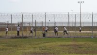 Detainees play outside during a media tour of the Port Isabel Detention Center (PIDC), hosted by U.S. Immigration and Customs Enforcement (ICE) Harlingen Enforcement and Removal Operations (ERO), in Los Fresnos, Texas, June 10, 2024. Behind barbed metal fences topped with barbed wire, men play volleyball and basketball at a detention center in Texas, passing time as they wait to hear if they will be allowed to stay in the United States. They are among more than 1,000 housed at this former naval base in the US city of Los Fresnos, just a few miles from the Mexican border, which they all crossed illegally. (Photo by Veronica G. Cardenas / POOL / AFP) (Photo by VERONICA G. CARDENAS/POOL/AFP via Getty Images)