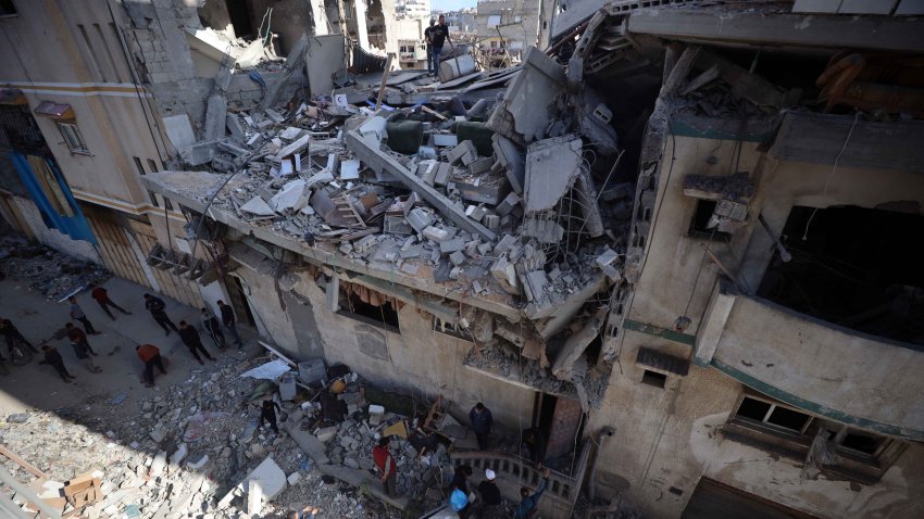 People inspect a house after an Israeli airstrike in Gaza City, on March 19, 2025. The Israeli military drops leaflets warning residents of what it calls ”combat areas” in the north and south of the besieged Palestinian territory, after Israel resumes airstrikes on Gaza following a ceasefire breakdown. (Photo by Majdi Fathi/NurPhoto via Getty Images)