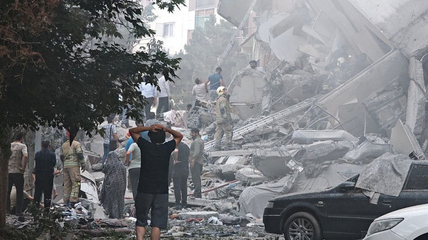TEHRAN, IRAN – JUNE 13: People look over damage to buildings in Nobonyad Square following Israeli airstrikes on June 13, 2025 in Tehran, Iran. Iran’s three top military generals were killed in the attacks that also targeted nuclear and military facilities, according to published reports. Israel described the strikes as preemptive to keep Iran from obtaining nuclear weapons, the reports said.  (Photo by Majid Saeedi/Getty Images)