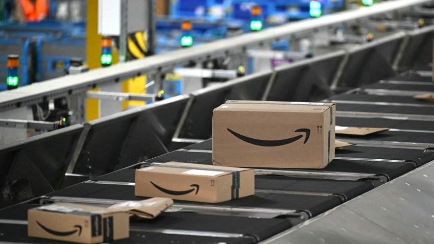 Amazon-branded cardboard boxes travel on an automated conveyor belt system inside Amazon’s LCY3 Fulfillment Centre in Dartford, east of London, on June 4, 2026, on the second day of company’s ‘Delivering the Future EMEA ’26’ event. (Photo by JUSTIN TALLIS / AFP via Getty Images)